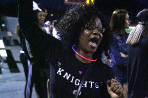 Donnell Hawkins’ mom, Laura Hawkins, cheers along side the Goonies at the varsity football game against Fort Zumwalt South. Hawkins has come up with some of the chants the Goonies cheer. The Knights won 43-27. (Photo by Sam Alexander)