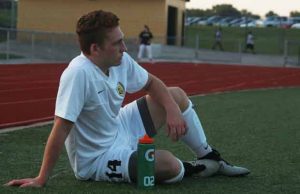Senior Connor Crain watches on from the sideline after suffering a leg injury in a match against St. Dominic on Sept. 22; he leads the Knights in scoring with nine goals on the season (Haleigh Schlogl)