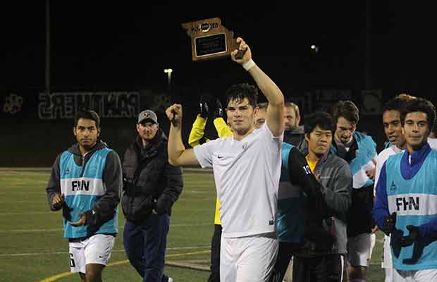 Senior Ozzy Guerrero raises the District Champions plaque after defeating FZW 2-0 on Oct. 27 (Adam Quigley)