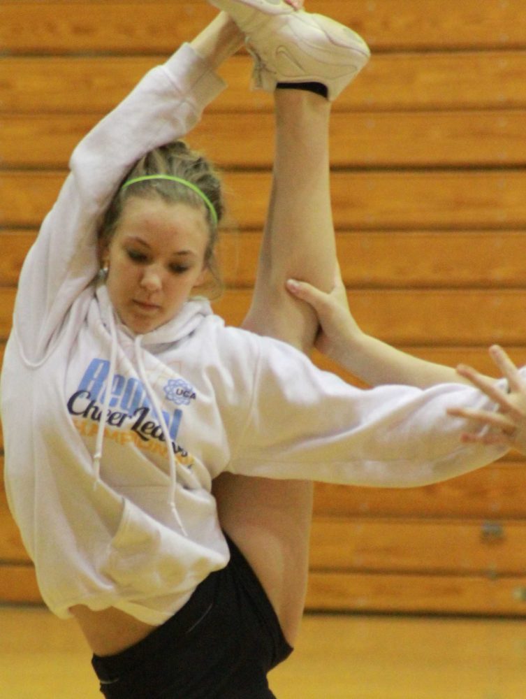 Cheerleaders had to stretch before they cheered in tryouts.