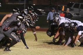 Varsity Football gets ready to make a play against their opponent. 