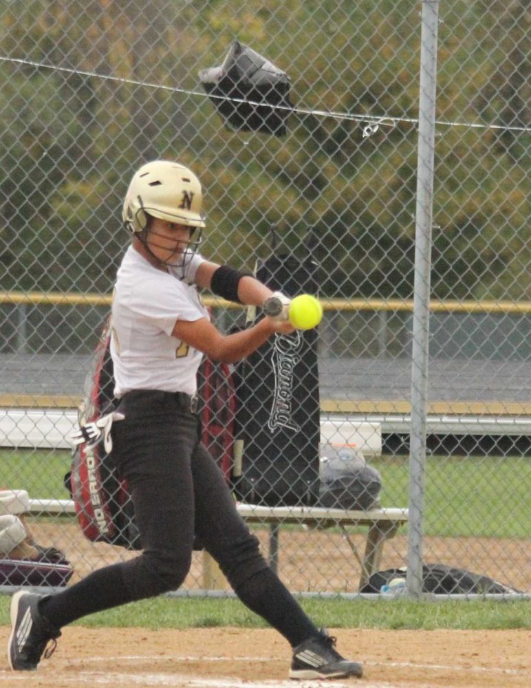 Brittany Frazier hits the ball at the first Varsity softball Districts game. This is Frazier's first year playing softball for North. 