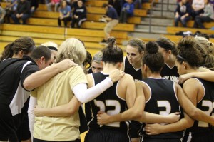 The Varsity Girls basketball team huddles. Photo by Megan Tanksley.