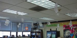 Student-created snowflakes hang from the ceiling of room 217.