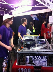 Dale Voege, the main driver, stands next to the Raven Robotics' robot at the St. Louis FIRST Robotics Competition.