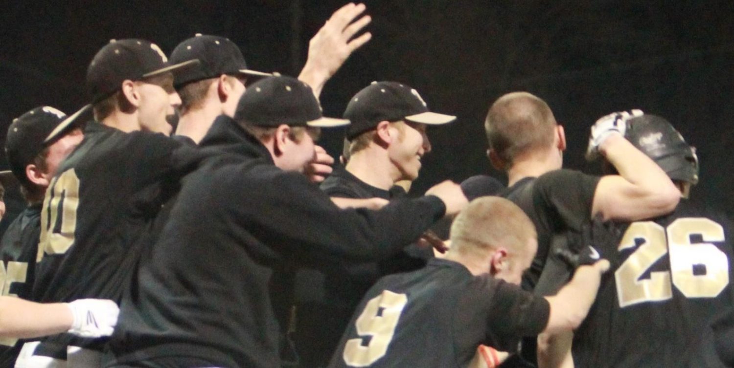 In the game against St. Charles West on March 15, before the Midwest Classic Tournament, Varsity baseball players celebrate a win with a score of 15-5. (photo by Matt Krieg)