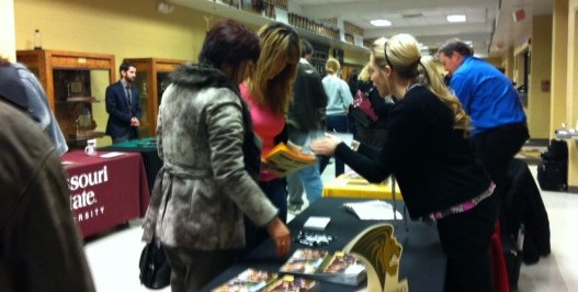 Junior Helen Yi speaks with a representative from Lindenwood University at FHN's annual College Night.