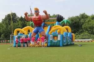 KOE members enjoy the inflatables after setting up for the picnic. (file photo)