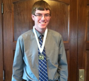 Nathan Rhomberg at last years luncheon wearing his medal after the ceremony. (Photo by Chelsie Hollis)