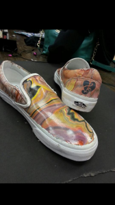 A plain white pair of Vans shoes were transofrmed into a music themed pair of shoes by a group of students in Zack Smithey's AP Studio Art class