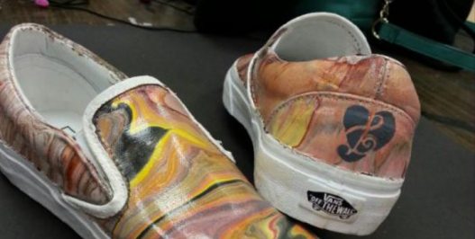 A plain white pair of Vans shoes were transofrmed into a music themed pair of shoes by a group of students in Zack Smithey's AP Studio Art class