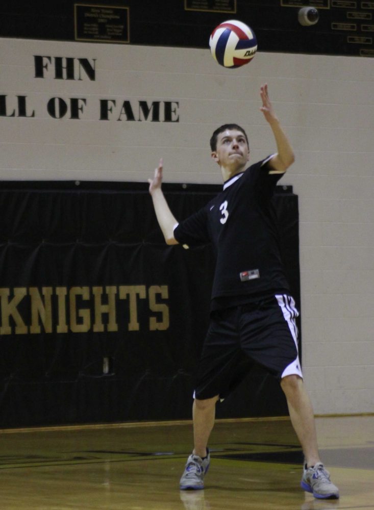 Junior defensive specialist, Jimmy Higgins, serves the ball over to Fort Zumwalt West's team on Friday, April 19 where North won. (photo by Murphy Riley)