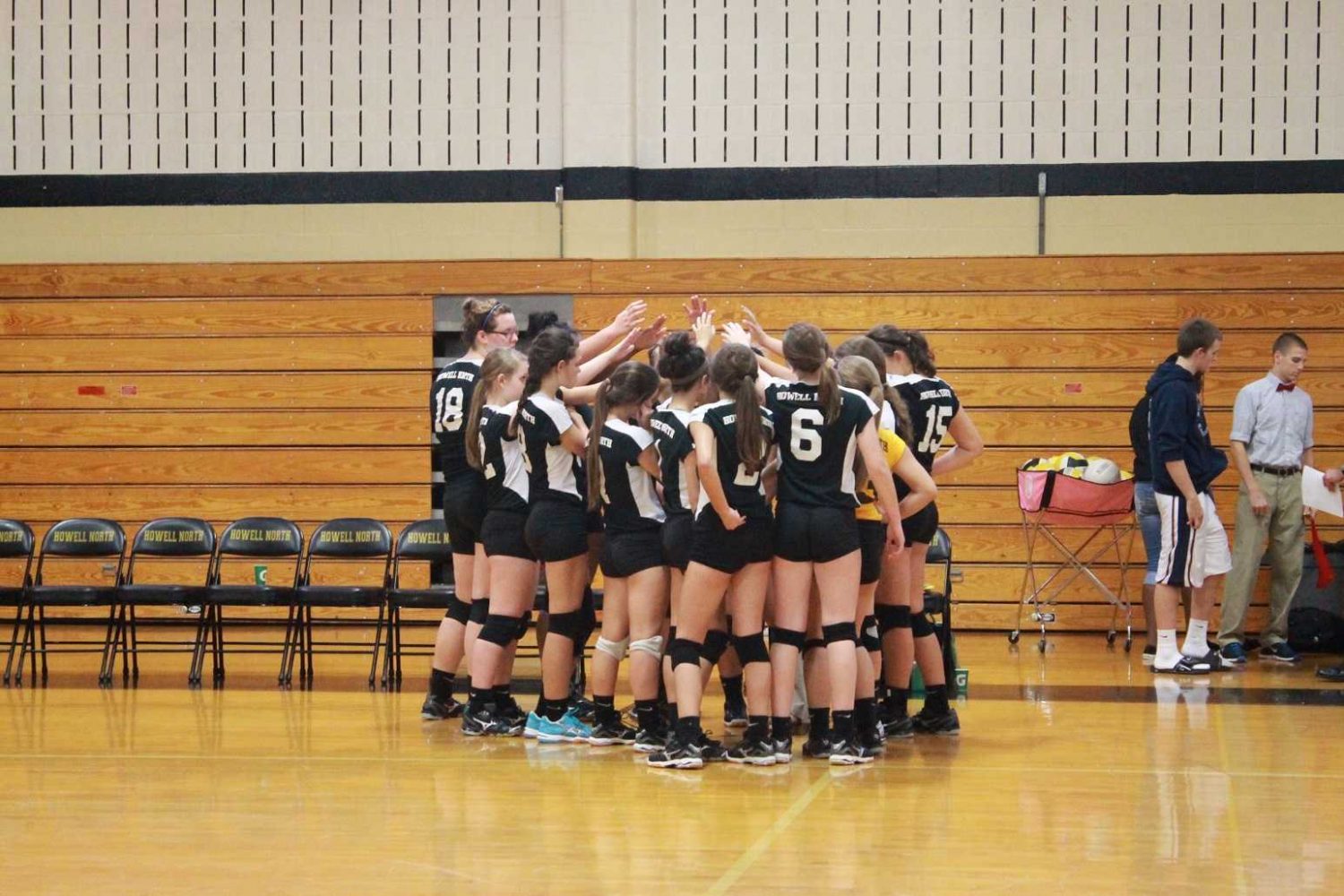 The freshmen volleyball girls huddle together before they start their game against Francis Howell Central.