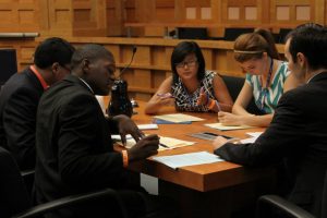 Senior Sophie Gordon, along with fellow Free Spirits, discusses the case with two lawyers. The scholars participated in a mock trial in front of a chief judge. (photo courtesy of the Newseum)