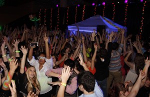 Students throw their hands up and dance at the Snowcoming dance last year.