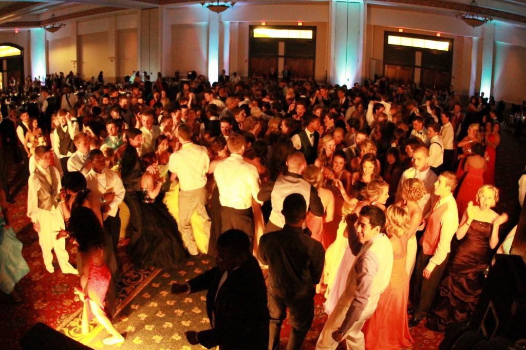 Students gather around to dance on the dance floor at last years prom, themed "A Night in Vegas".