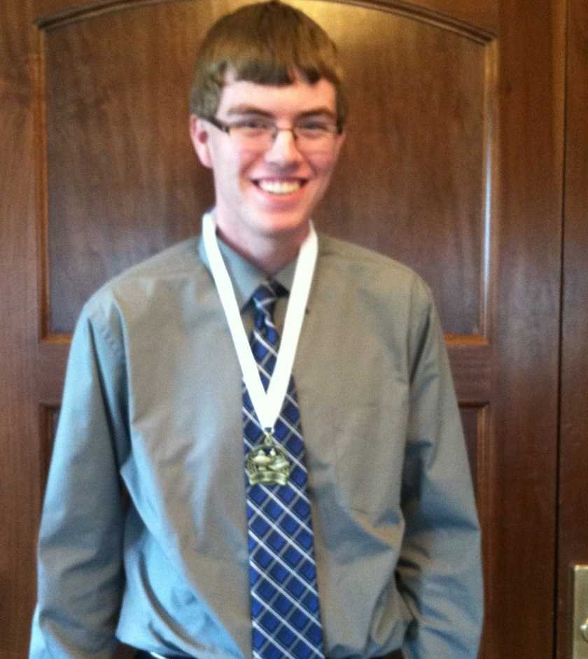 Nathan Rhomberg at last years luncheon wearing his medal after the ceremony. (Photo by Chelsie Hollis)