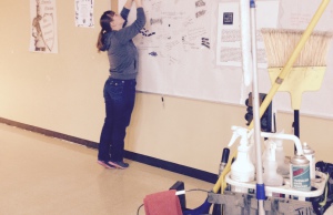 Tessa Smith working on hanging up everyones pledge to be apart of our no place for hate school.