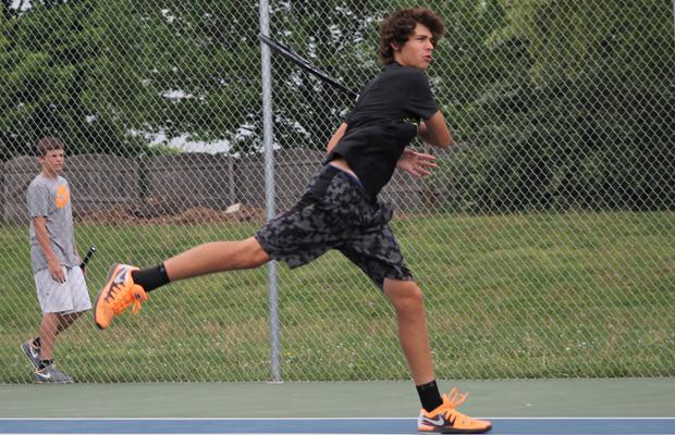 Senior Matt Dude hits a ball back to his opponent