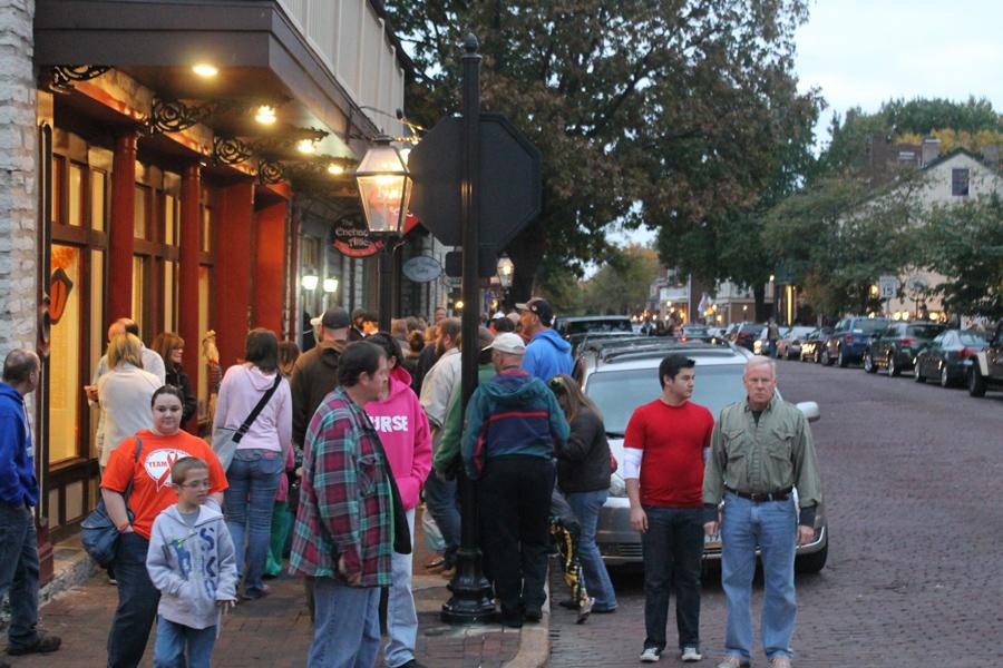 Pedestrians on Main Street walk around looking at the stores that were open later than normal. Stores are usually open until 5 p.m., but during the Pumpkin Glow most stores were open until 8 p.m. Many stores offered samples or demonstrations. 