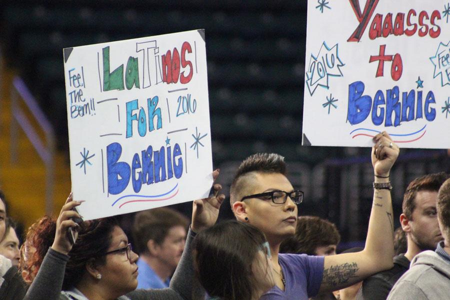 Two women hold handmade signs up in the air. Senator Sanders has spoke on the issue of racism and sexism in America. Sanders brought up topics like wage gaps between men and women and reforms to the criminal justice system.