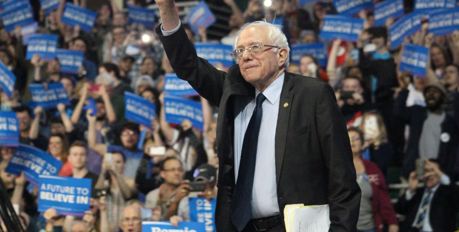 Bernie Sanders waves at the crowd as he walks out on stage. The rally took place in the Family Arena in St. Charles, MO. There were approximately 5,500 people in attendance