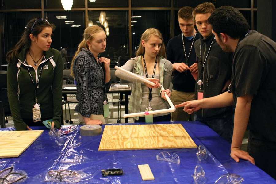 Estefania Cruz-Castillo, Amber Pryor, Caitlind Walker and other students watch an engineer during their monthly meeting at Boeing. Boeing is the world’s largest aerospace company that designs, manufactures and sells airplanes, rotorcraft, rockets and satellites. (Photo by Madi Graves)