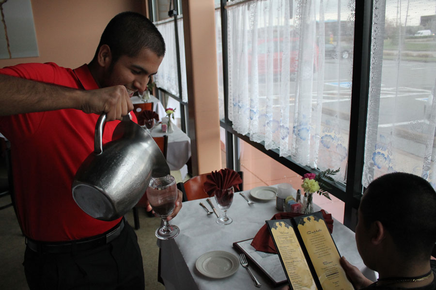 Sohail pours water for a customer. The Taj Palace has a lunch buffet from 11:30 am to 2:15 pm everyday. The dinner service on Monday thru Thursday is 5:00 PM to 8:30 pm for dining in and carry out is until 9:00 pm. Friday thru Saturday dinner service is from 5:00 pm to 9:30 pm and carry out is until 10:00 pm. 