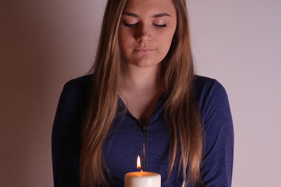 Sophomore Madison Meers holds a single lit candle to signify her life. Madison is involved with the school yearbook and works at Fazolis.