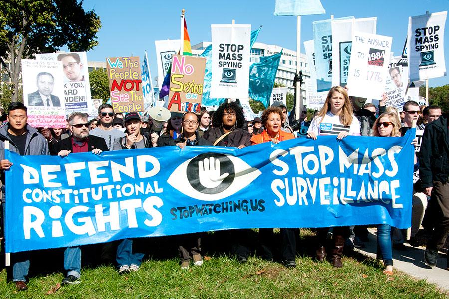 WASHINGTON - OCTOBER 26: Protesters rally against mass surveillance during an event organized by the group Stop Watching Us in Washington, DC on October 26, 2013. (Rena Schild / Shutterstock.com)