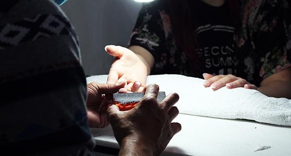 Brown gets her nails buffed. The reasoning behind buffing nails is so it makes it easier to apply the nail polish. 