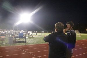 The new marching band director, Robert Stegeman, watches as FHN’s band plays during the half time preformance for the crowd at the first football game of the year on Aug 19. (Photo by Jared Kinnard)
