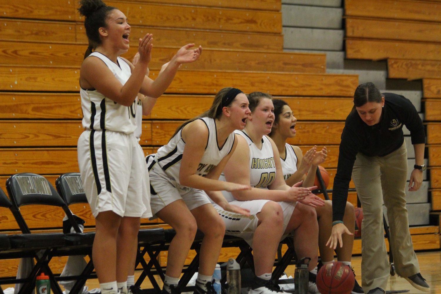 Anna Wiley cheers on the rest of JV team as during the game against Holt High School on Dec. 13. The team lost the game 24-26.