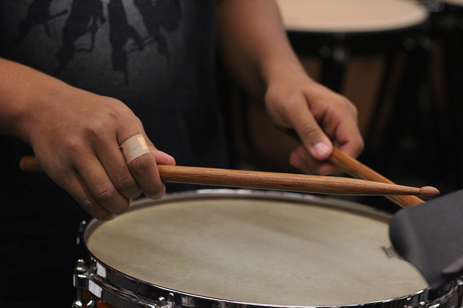 Freshman Jayden Jaeger practices playing snare drum in the band room. Students in percussion ensemble practice for the first time on Dec. 1. The students were expected to play instruments that they might not normally play. They will have months to practice their pieces before their first performance on Feb. 16.