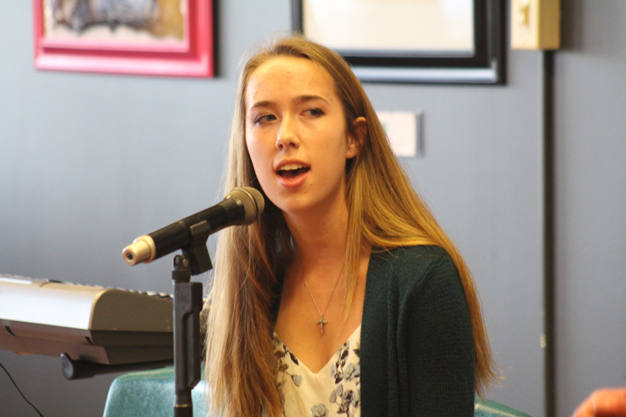 Senior Amy Wedewer sings in front of the Coffeehouse Day One audience. The Coffeehouse is an annual event hosted by the FHN Learning Commons.