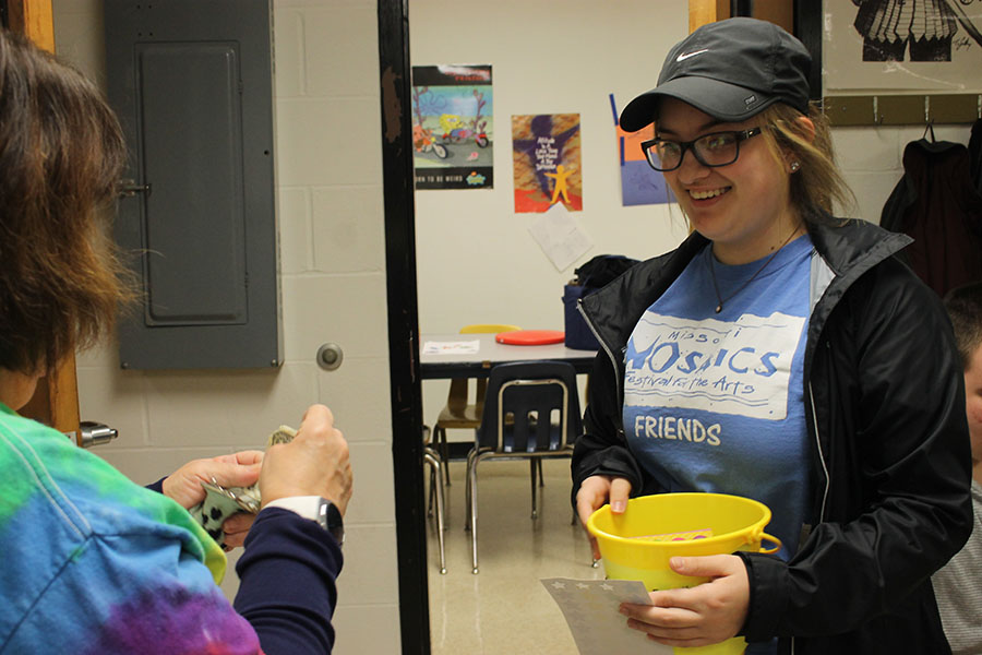 FHN junior Brooke Williams collects hat day money for the Schwartz family. 