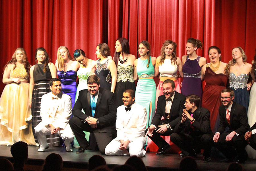 Participants in last years' prom fashion show  pose on stage during the event. 