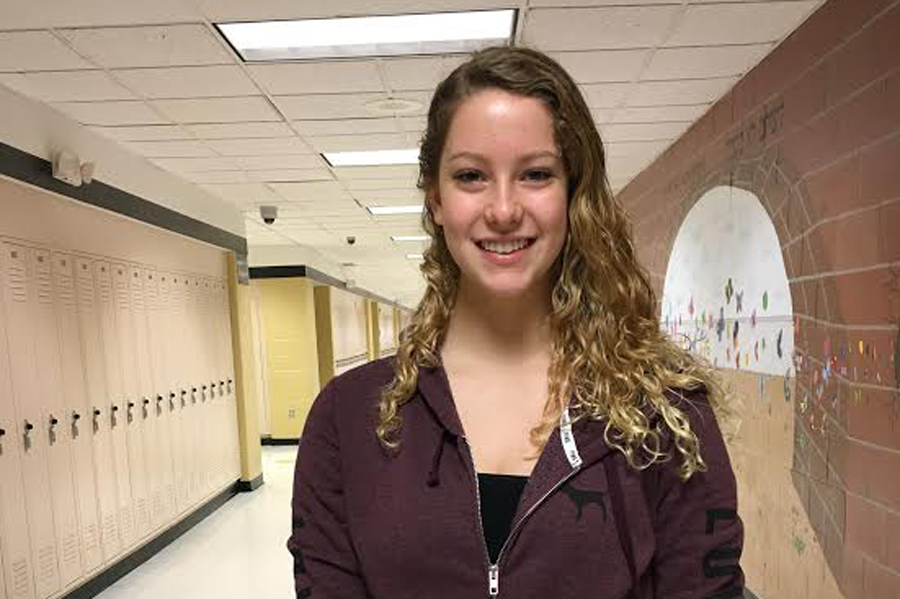 Senior Katherine Hassinger poses in the butterfly hallway. 