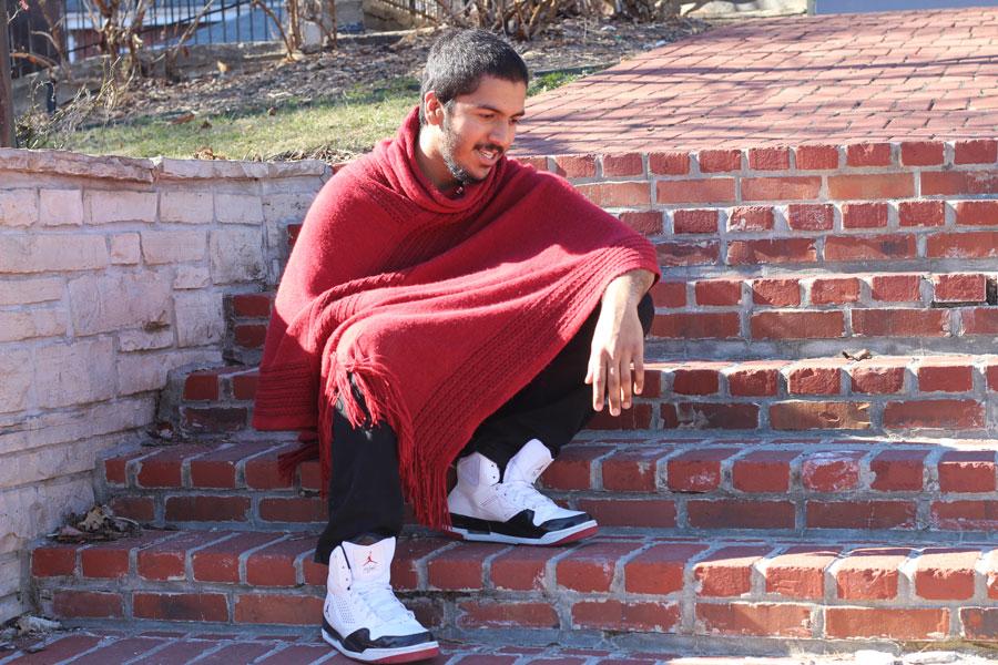 Alumnus Sohail Jchaj poses on the steps to the Main Street St. Charles gazebo. Jchaj was known at FHN for creating mixtapes for students to enjoy, and is currently pursuing his passion for the arts and making a difference in the lives of others.