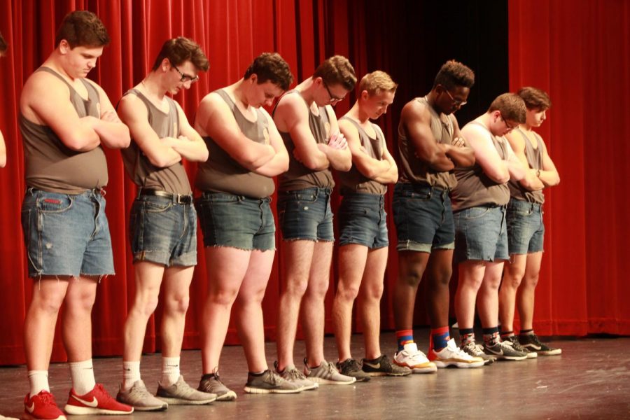 Mr. FHN contestants lineup before their opening dance number, crossing their arms and bowing their heads. The Mr. FHN contestants danced to a mashup of songs that included "It`s Raining Men," "Hips Don`t Lie," "Juju On the Beat" and others. Mr. FHN is an annual fundraiser event for the students at FHN. Contestants raised money to their said charity, and then performed on April 21 in the auditorium, tickets were $5 at the door. 