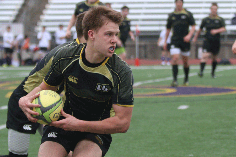 Rugby player takes possession of the ball in an away rugby match.