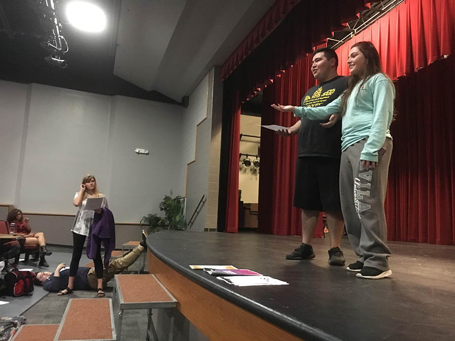 Emcee's Bria Smith and Brian Ochoa rehearse for tomorrows performance, as co-student director Sydney Weber looks on. 
