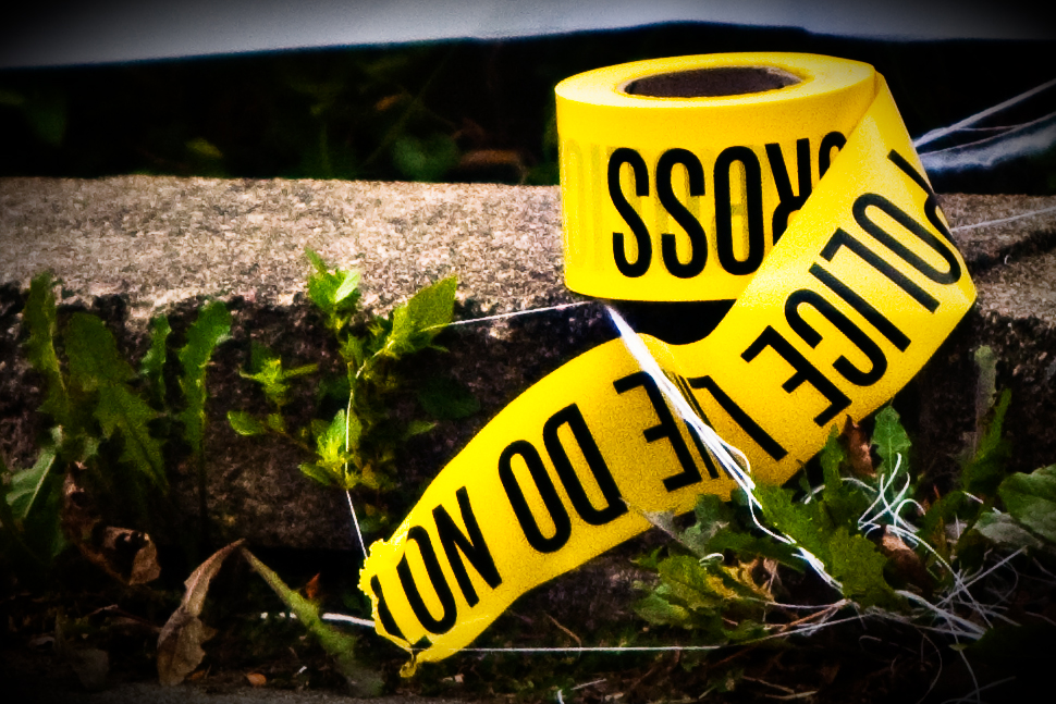 A roll of police line tape sits outside Rosemary Williams' home. (used with permission from Creative Commons)