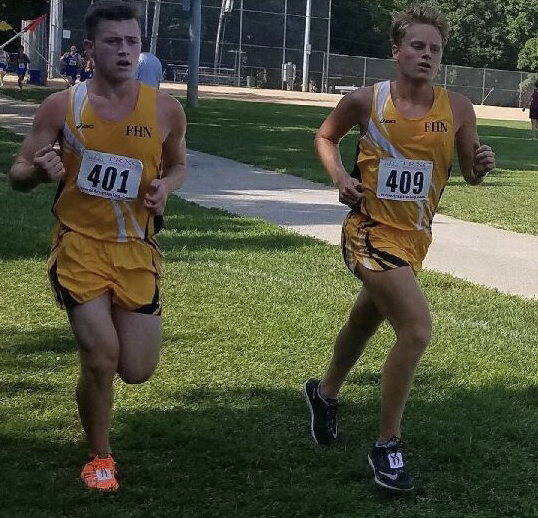 Seniors Ben Jamison and Alex Baker running in a cross country meet at McNair Park. 