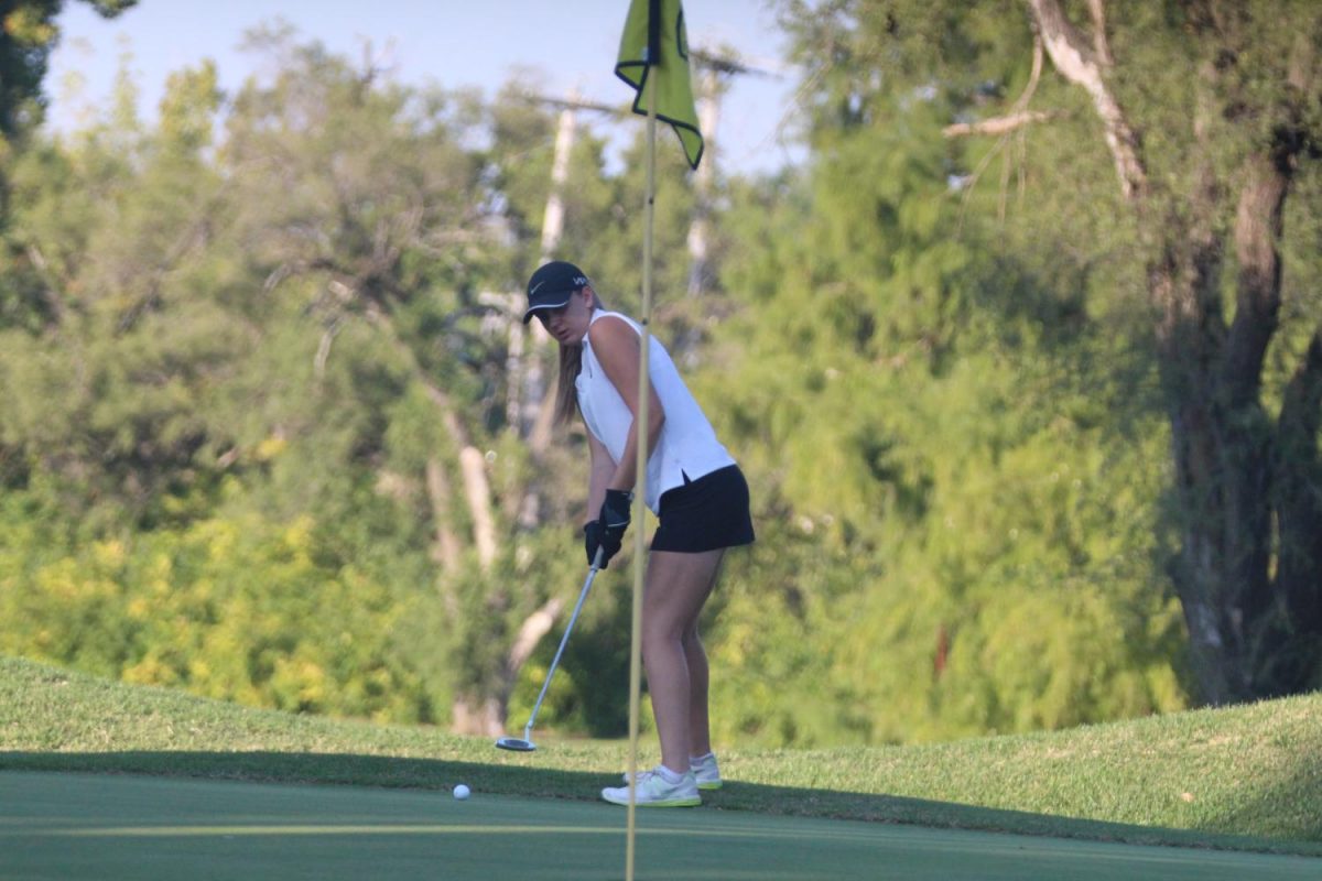 Senior Briana Schmidt prepares for a short putt in a match on 9-14.