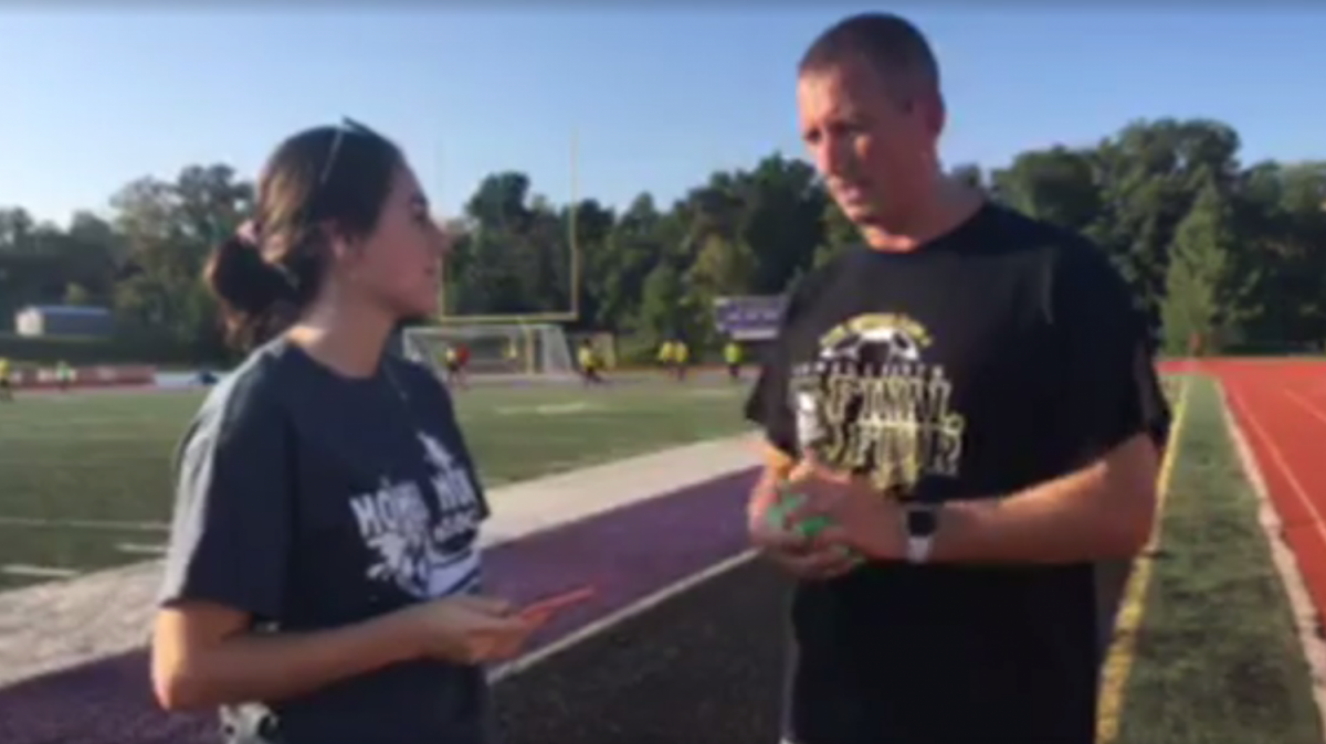 Senior Jamie Sneed talks with Boys Soccer coach Larry Scheller before a game at Fort Zumwalt West.