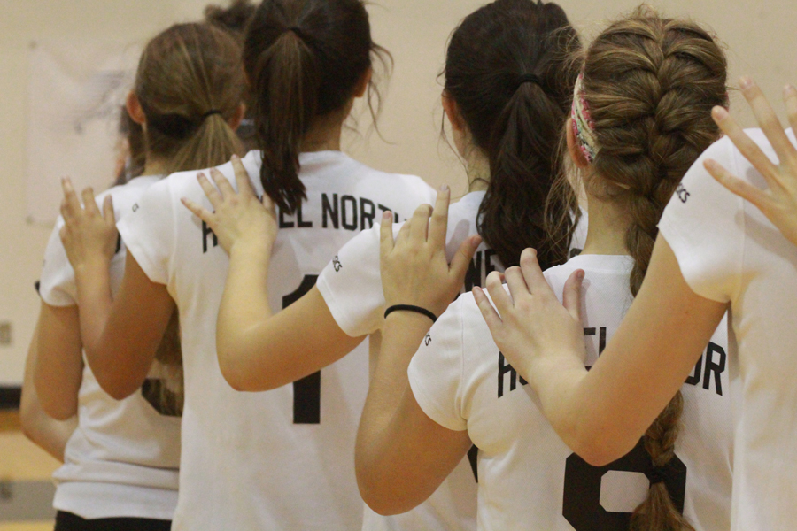 Girl Varsity volleyball lines up for National Anthem before match against FZW on 9/19.