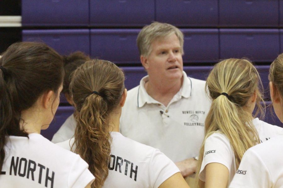 Coach Kent Stover gives a pep talk to his team before the match.