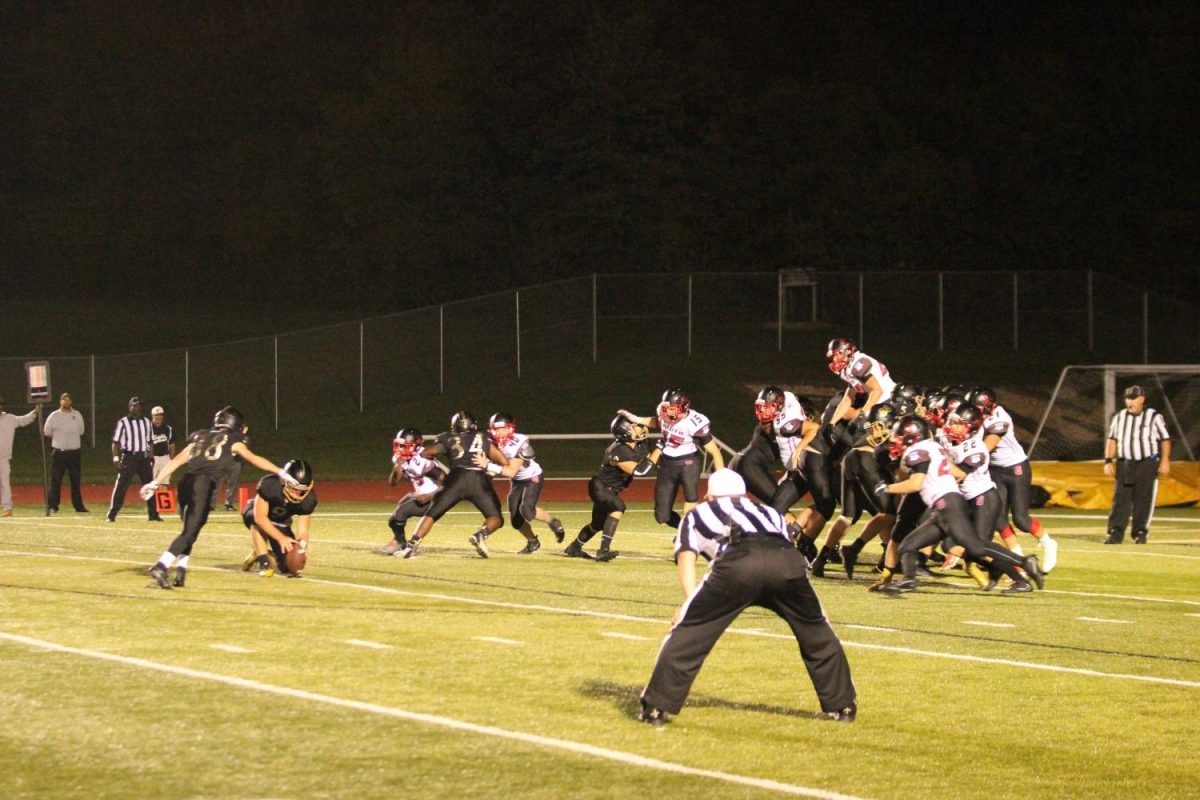 Junior Anton Coelen runs up to attempt a PAT to beat the Ft. Zumwalt South Bulldogs.