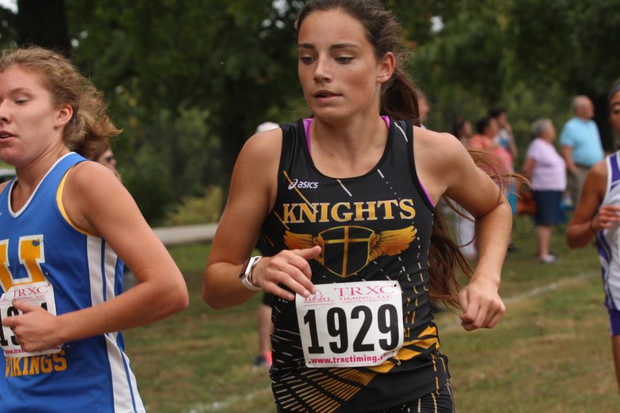 Junior Claire Huss participating in cross country meet